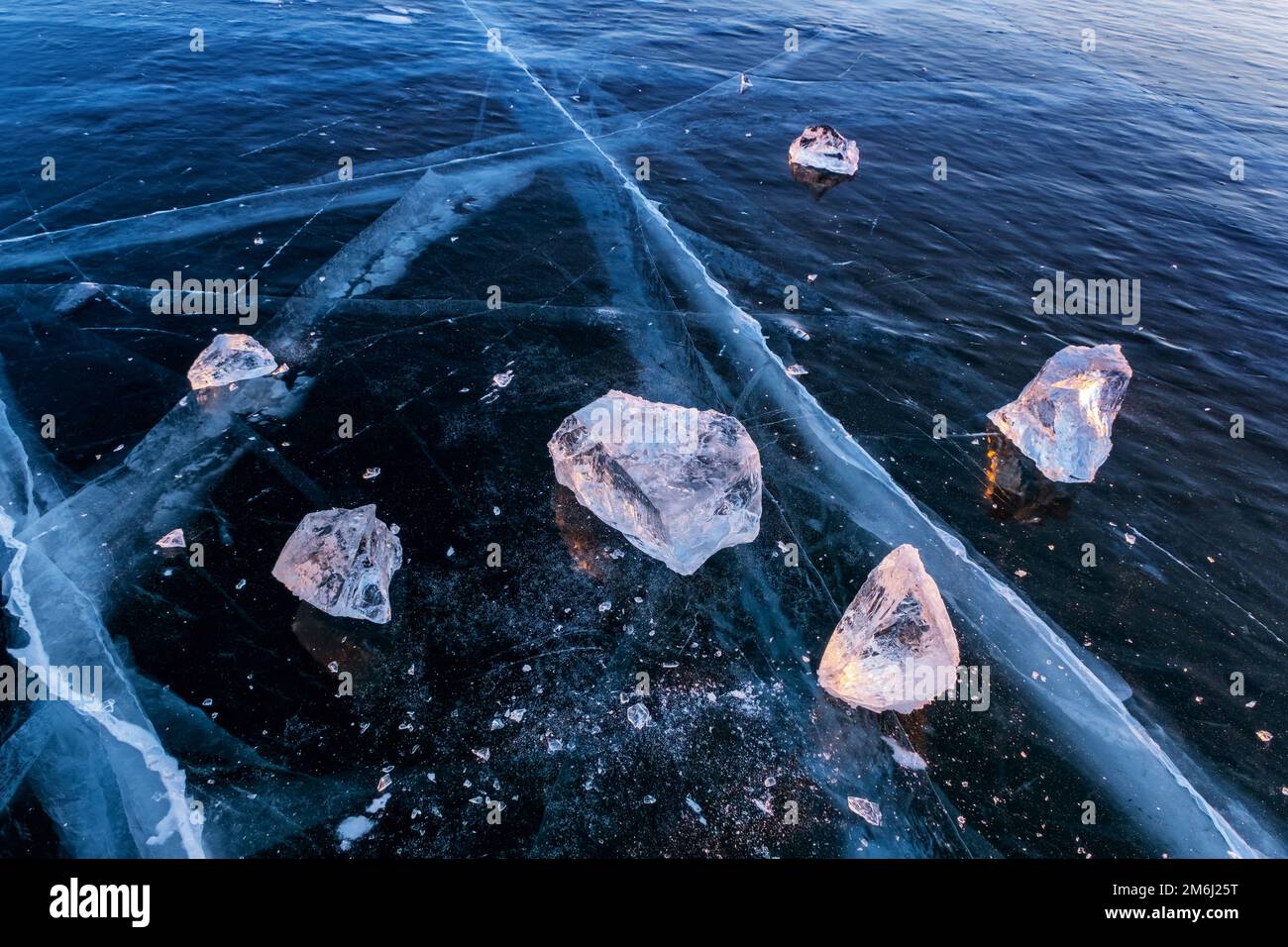 Frozen Lake Baikal at sunset Stock Photo