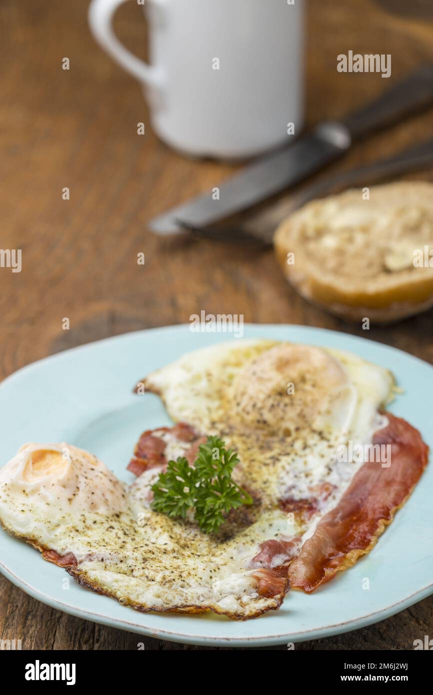 Bacon with fried egg on wood Stock Photo