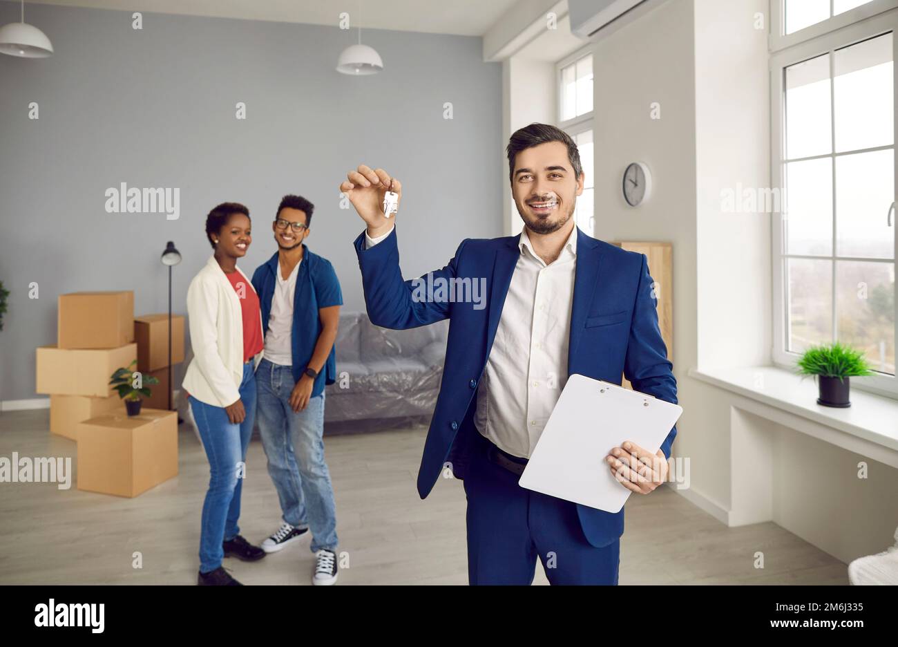 Man relator congratulate ethnic couple with house buy Stock Photo