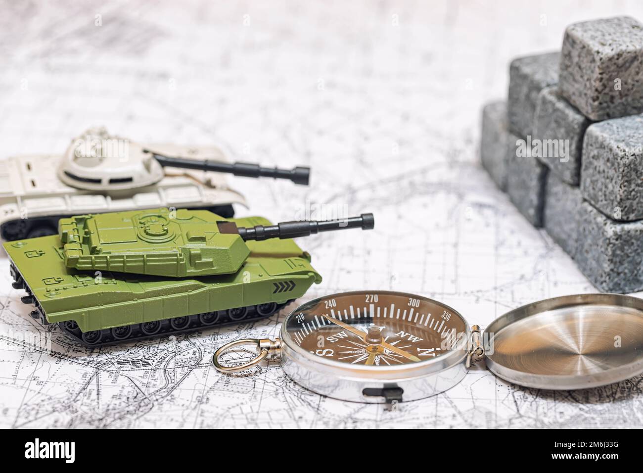 Toy models of tanks jointly attack enemy fortifications Stock Photo