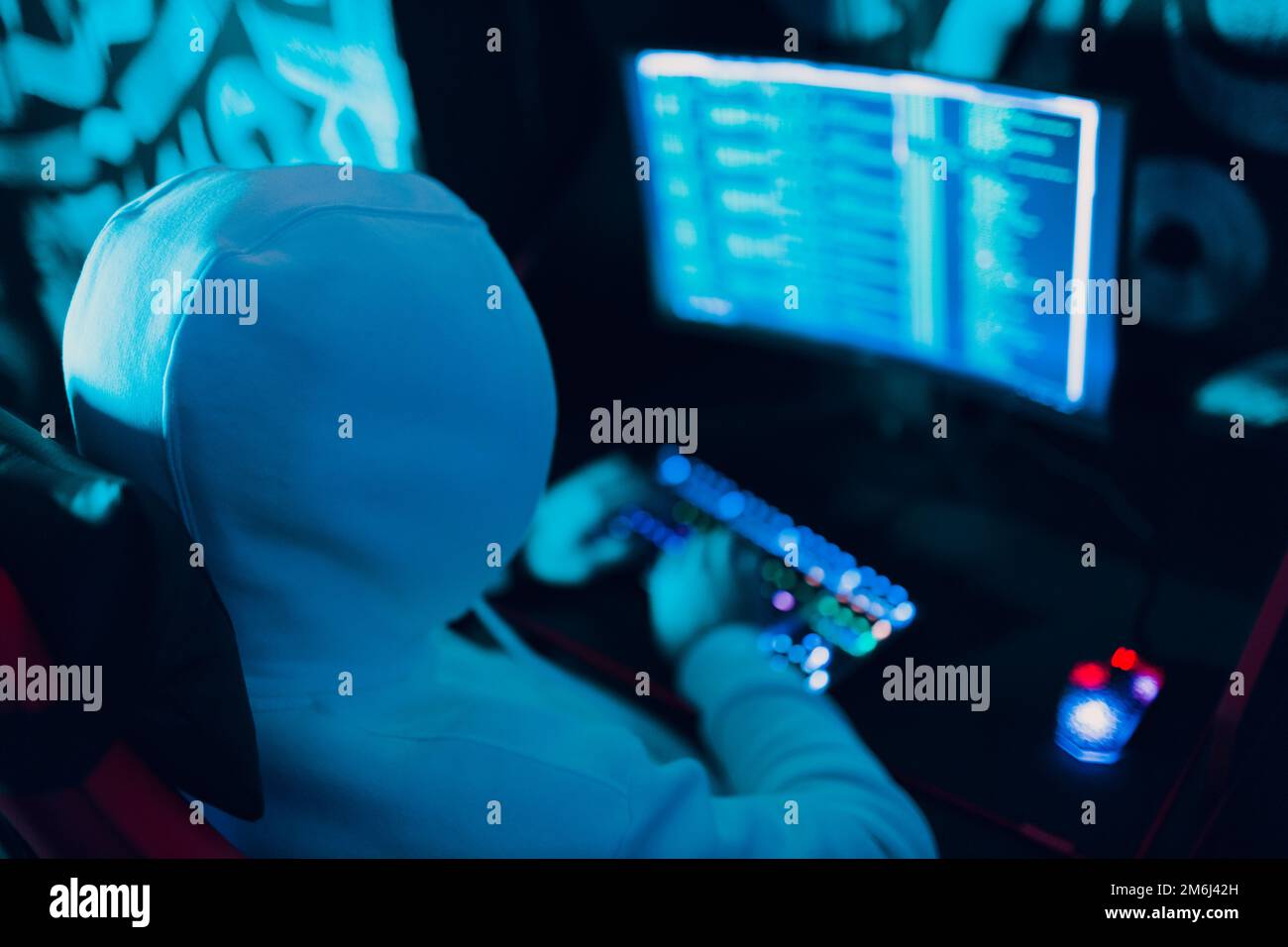 Hacker using computer malware software and hacking binary code digital interface. Stock Photo