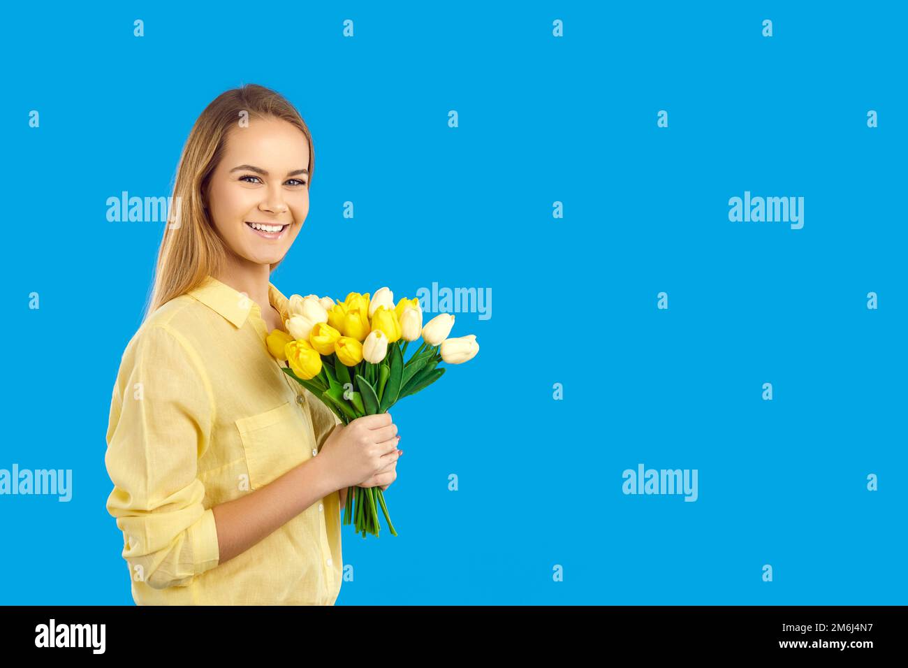 Smiling woman hold flower bouquet in hands Stock Photo