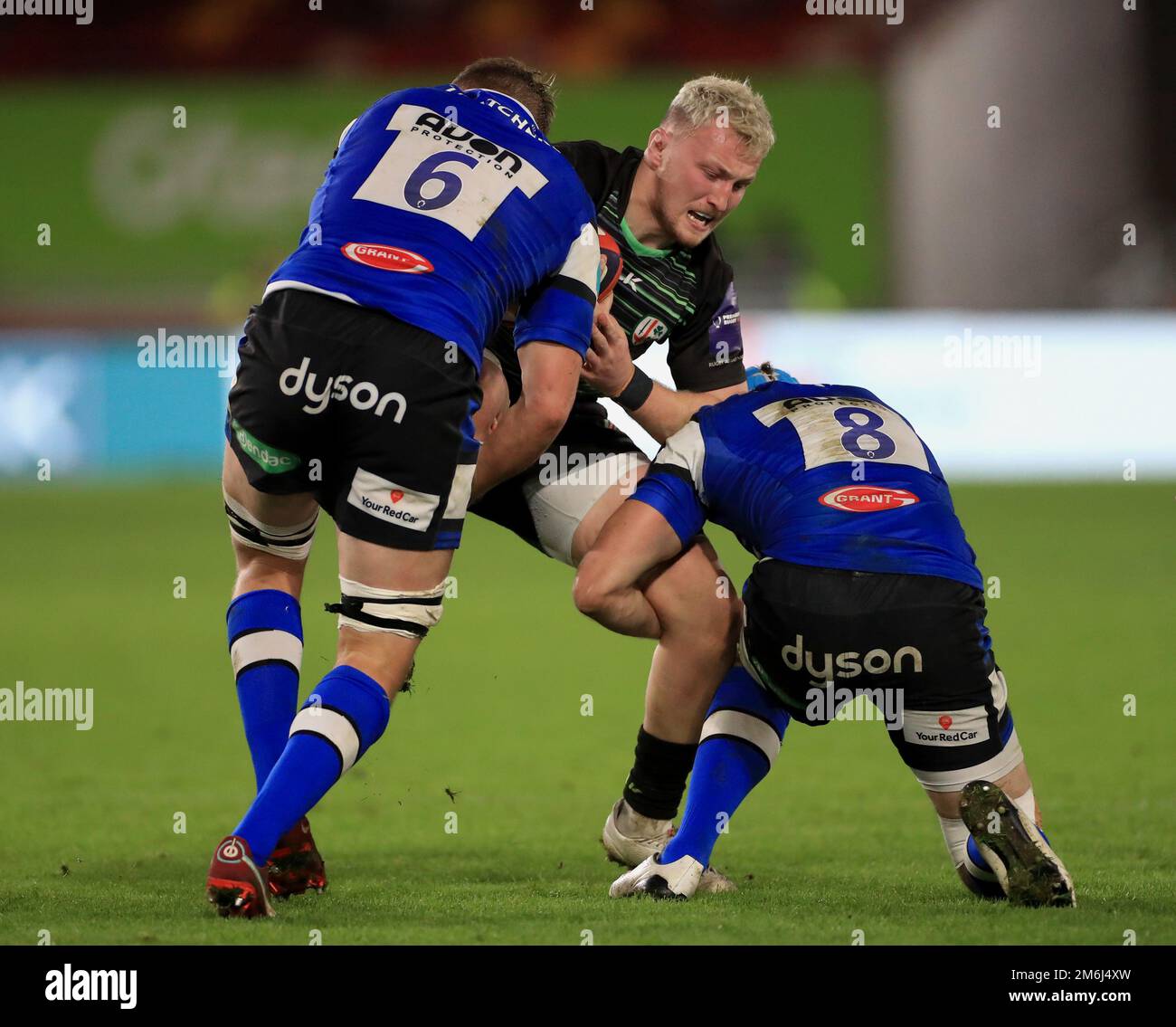 London Irish's Ben Atkins is tackled by Bath's Tom Ellis (left) and Wesley White during the Gallagher Premiership match at the Gtech Community Stadium, London. Picture date: Wednesday January 4, 2023. Stock Photo
