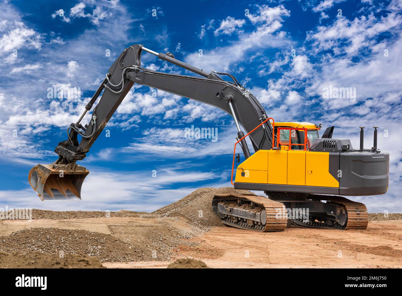 Heavy excavator working on construction site Stock Photo - Alamy