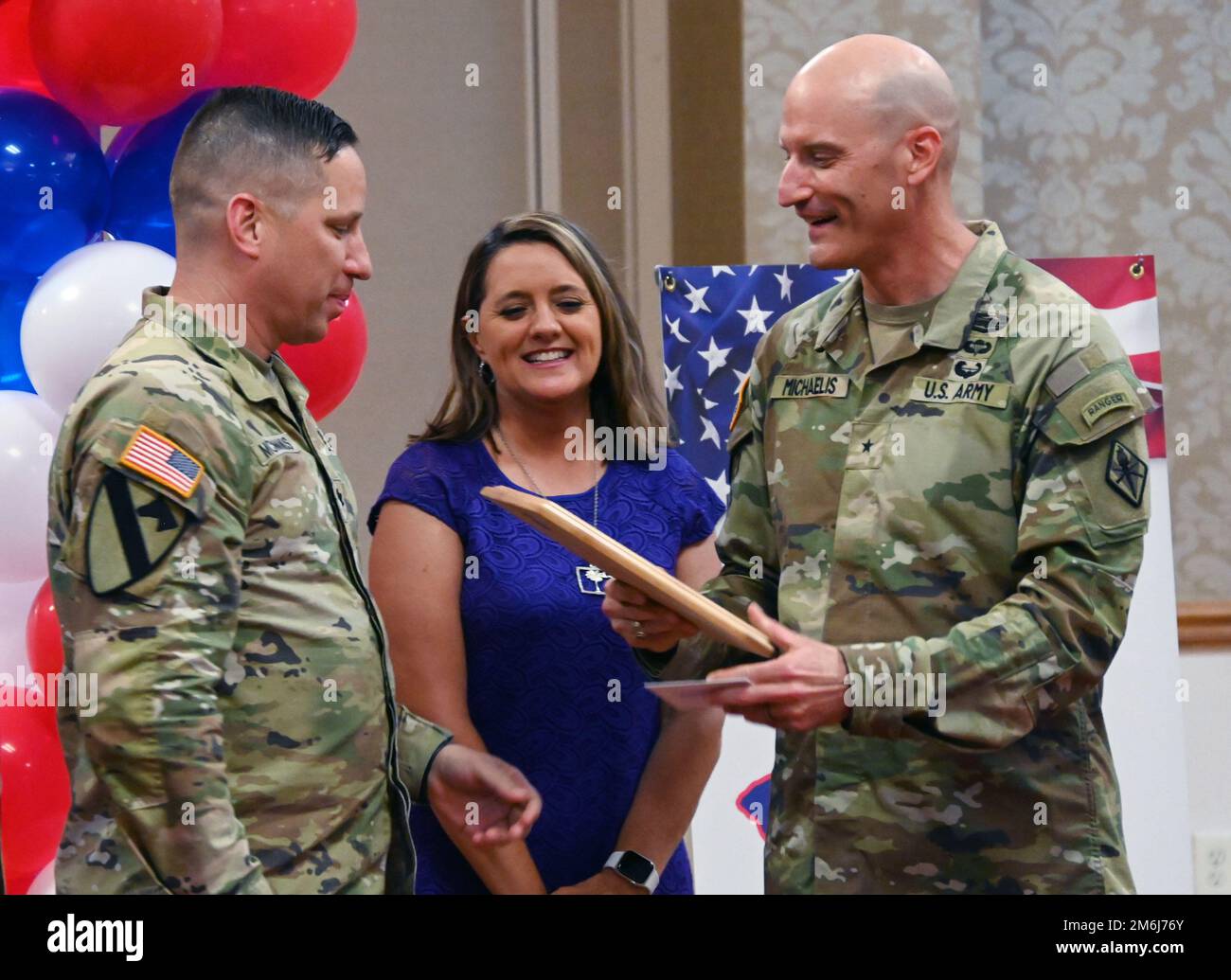 Lt. Col. Paul McManus, commander of 3rd Battalion, 60th Infantry Regiment, accepts a volunteer of the year award on behalf of his wife Kate during the Family of the Year/Volunteer of the Year ceremony April 28. Stock Photo