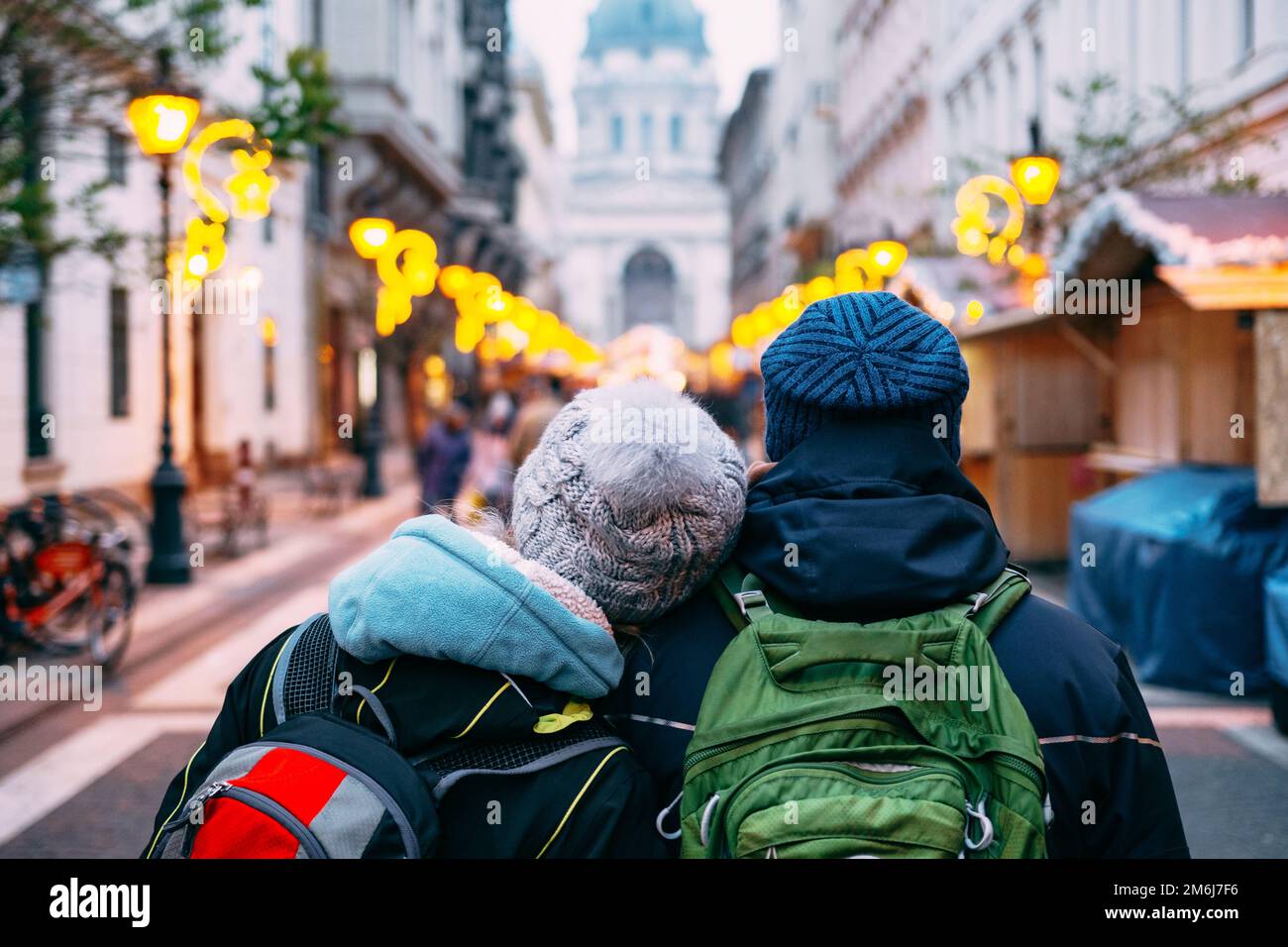 A couple of tourists in love walks around Budapest against the background of St. Stephen's Basilica. Stock Photo