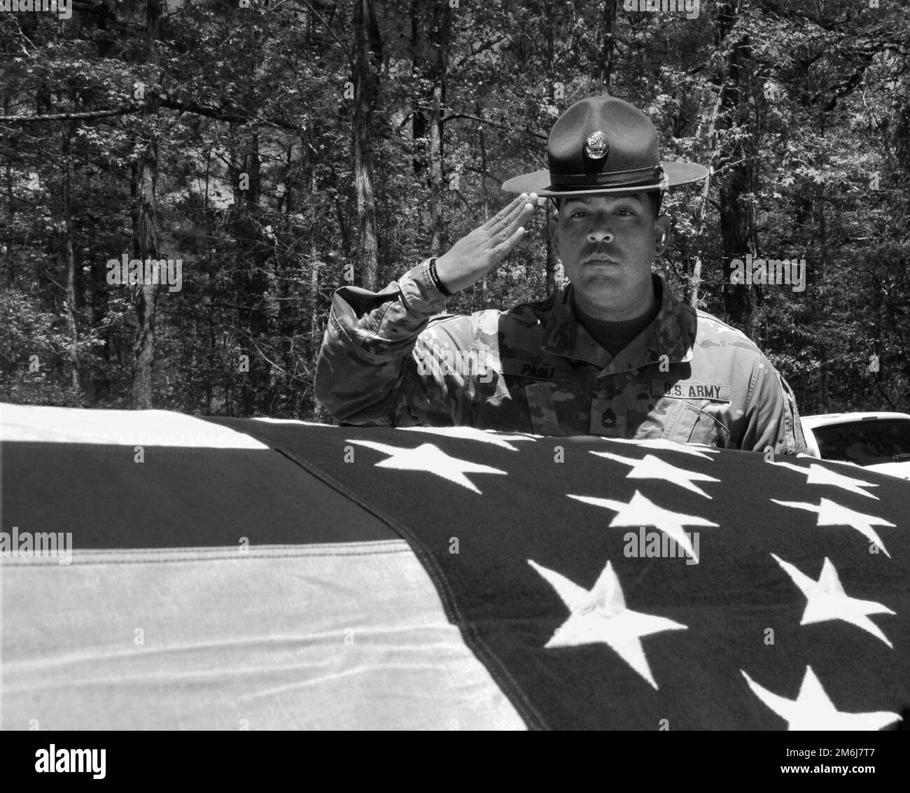 Sgt. 1st Class Waldemar Paoli IV, Delta Company, 832nd Ordnance Battalion, salutes a flagged-draped casket during a funeral honors detail practice session conducted April 28 at Training Area 23. Soldiers assigned to the detail undergo five days of focused instruction prior to performing the duties at an actual ceremony. Stock Photo