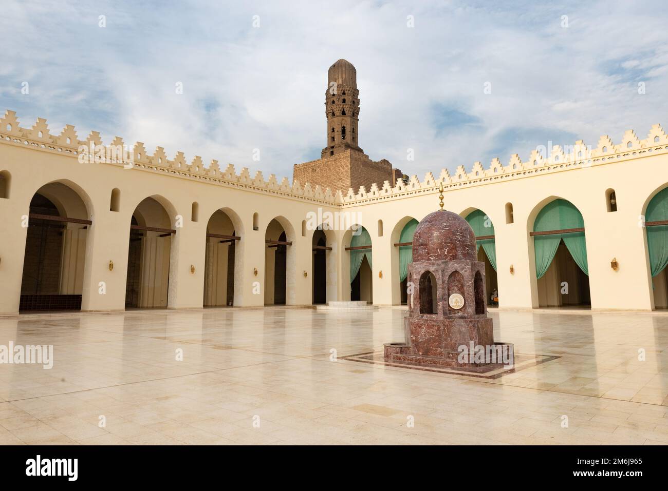 Cairo, Egypt, November 26th 2022 Minaret and ablutions fountain of historic Mosque of al-Hakim, also known as Al-Anwar, named after Al-Hakim bi-Amr Al Stock Photo