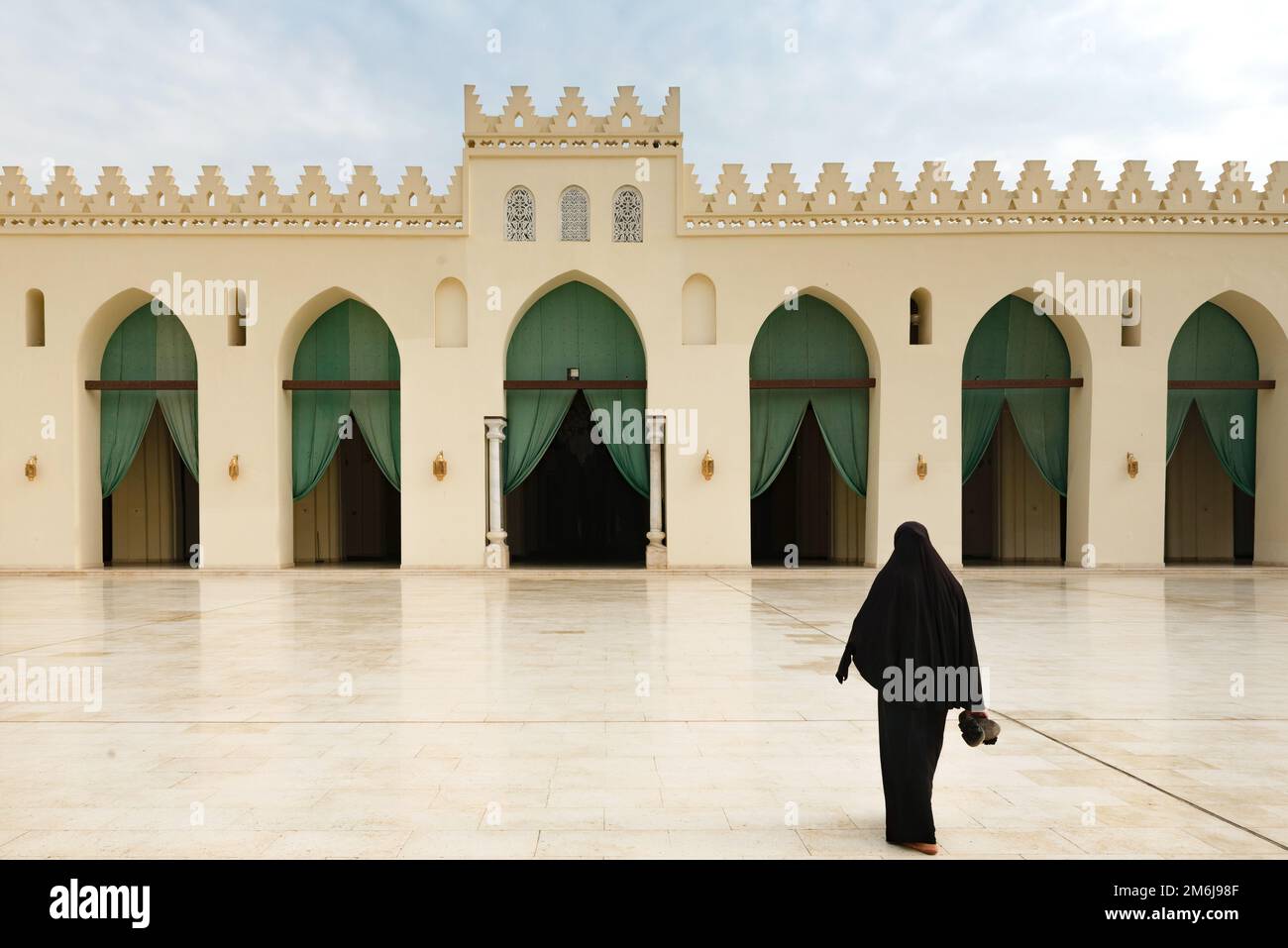 A Muslim women entering the prayer hall of historic Mosque of al-Hakim, also known as Al-Anwar, named after Al-Hakim bi-Amr Allah. Just inside the Fat Stock Photo
