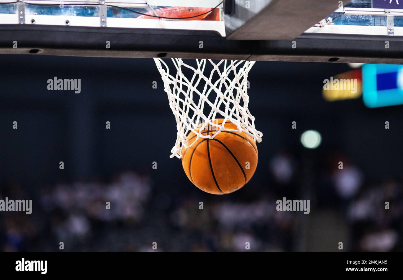 Basketball game ball in hoop Stock Photo Alamy