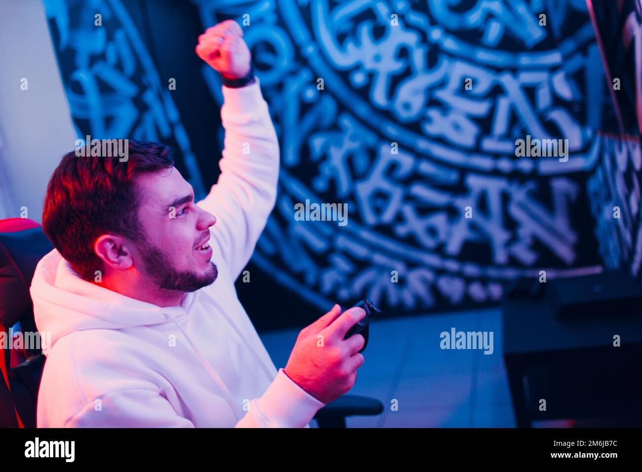 Guy young adult man playing video game on game console at computer