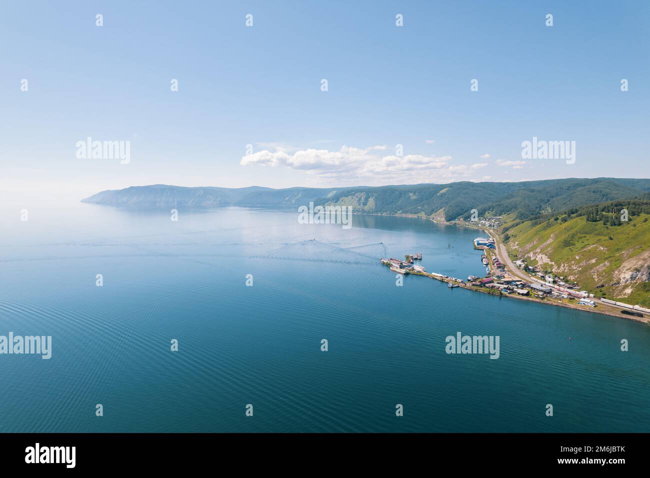 Lake Baikal is a marvelous blue jewel framed by scenic mountains and forests. Epic cinematic aerial view Lake Baikal. Aerial vie Stock Photo