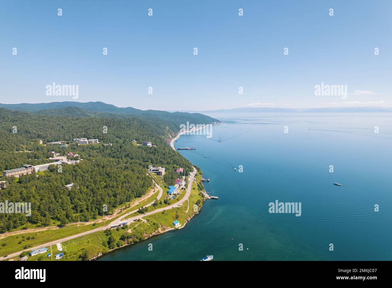 Lake Baikal is a marvelous blue jewel framed by scenic mountains and forests. Epic cinematic aerial view Lake Baikal. Aerial vie Stock Photo