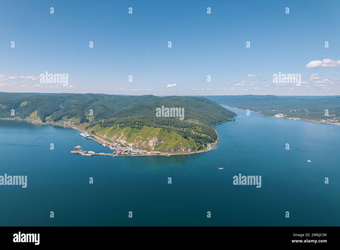 Lake Baikal is a marvelous blue jewel framed by scenic mountains and forests. Epic cinematic aerial view Lake Baikal. Aerial vie Stock Photo