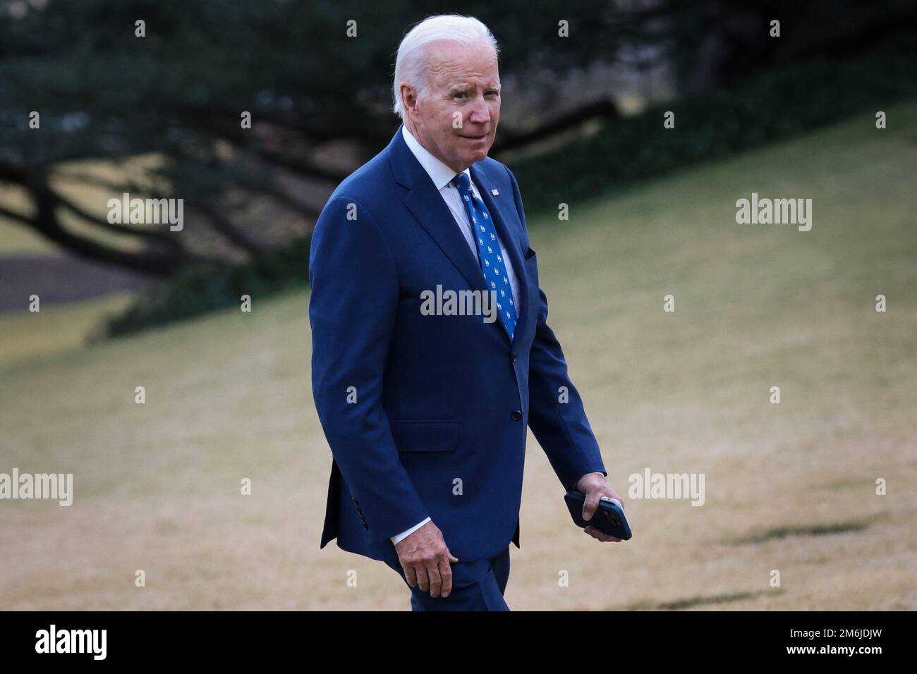 U.S. President Joe Biden walks on the South Lawn of the White House as ...