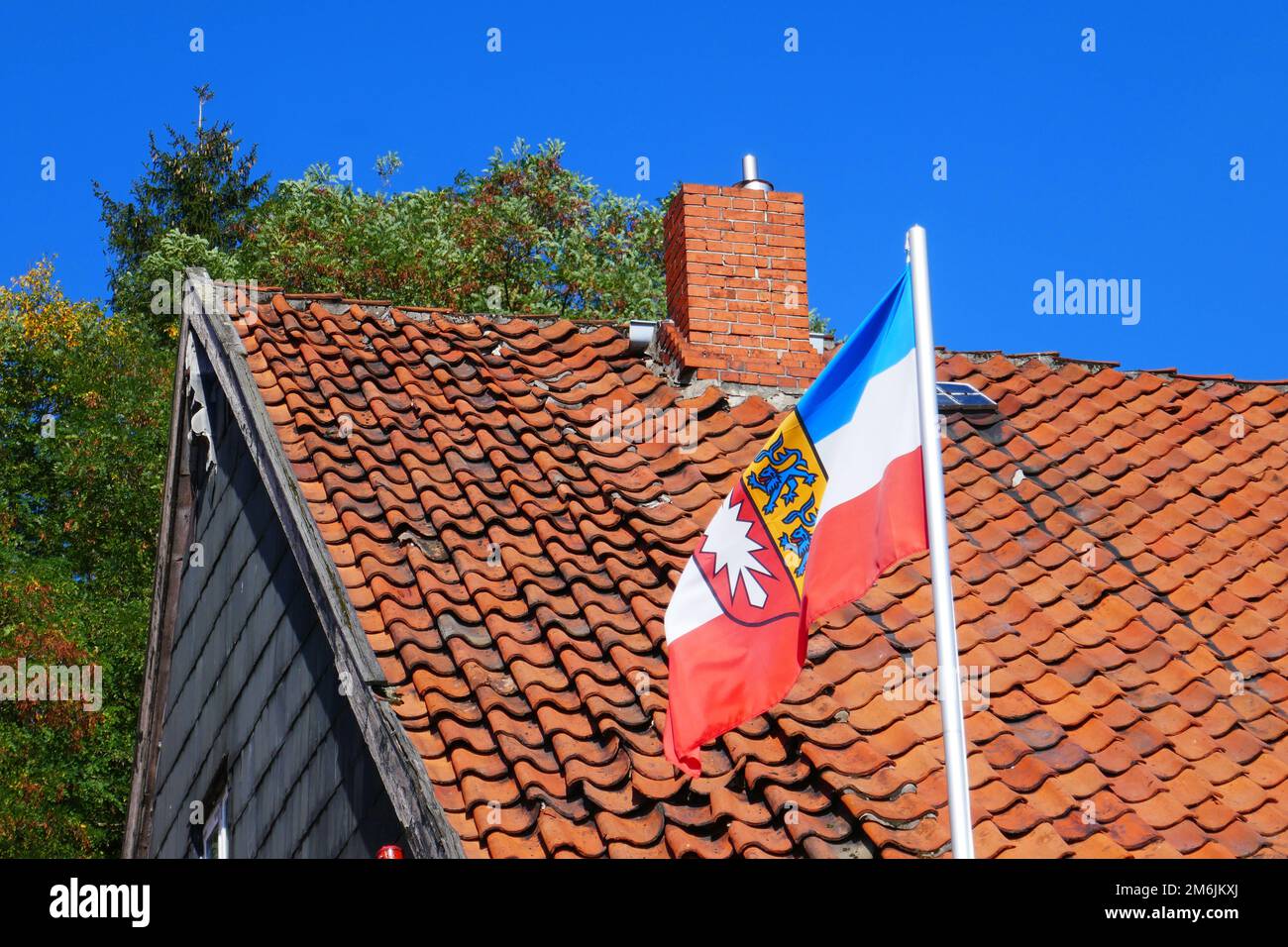 Hoisted flag of Schleswig Holstein in Lauenburg Germany Stock Photo