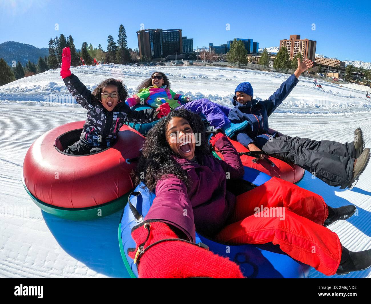 A family takes a selfie as they snow tube in Stateline, Nevada Stock