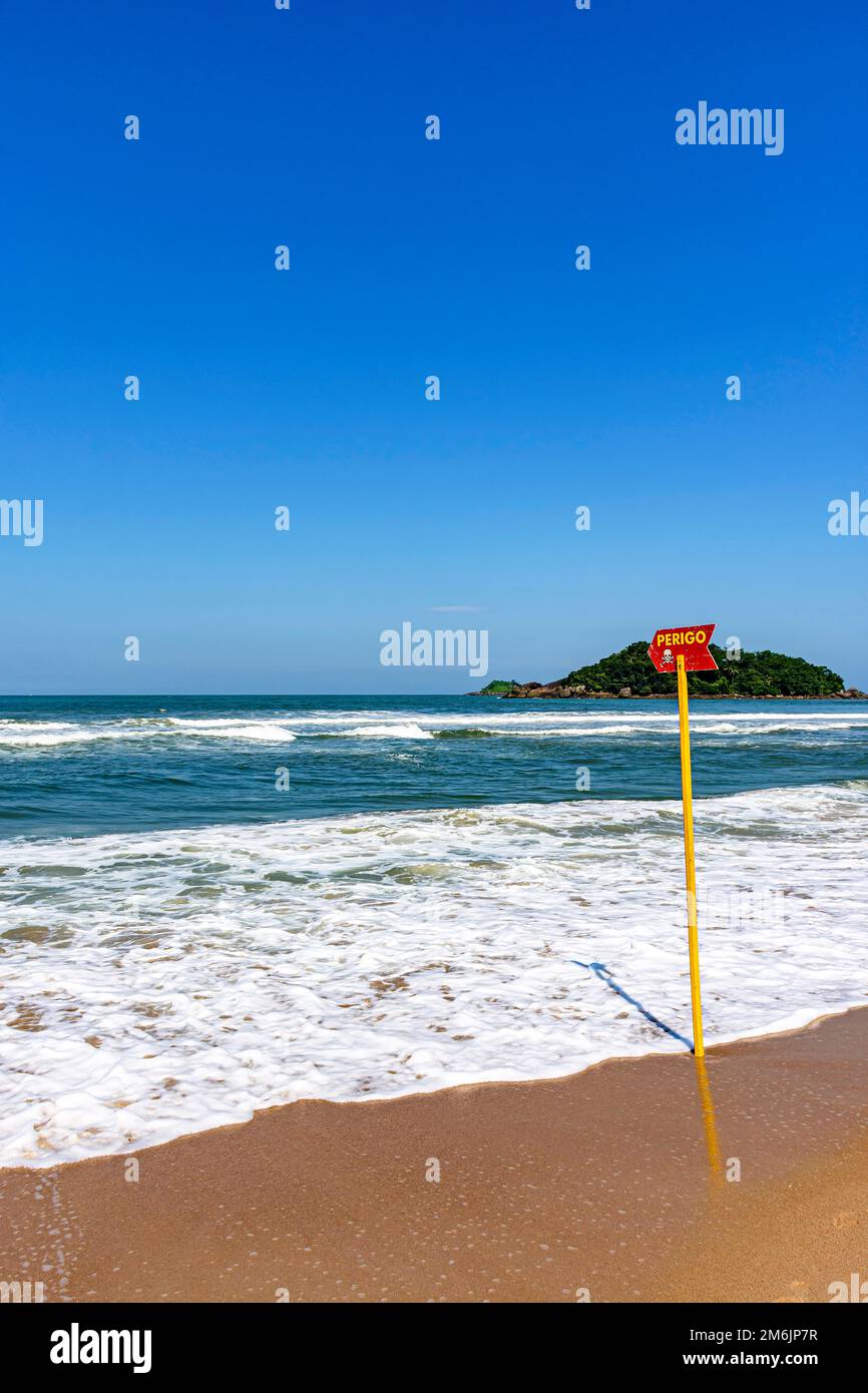 Paradise beach with danger warning from waves and sea currents Stock Photo