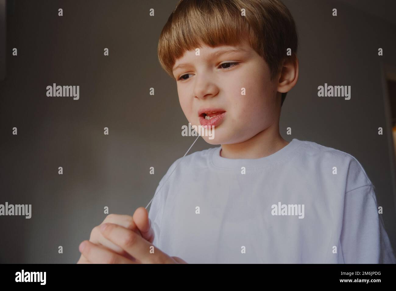 Closeup portrait of a kid removing his milk teeth, two rows Stock Photo