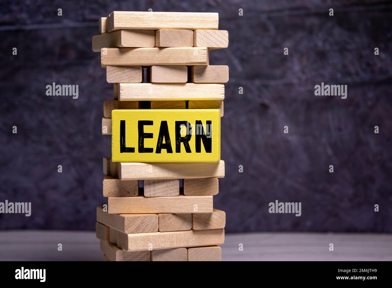 Learn or earn symbol turned a cube and changed the word earn to