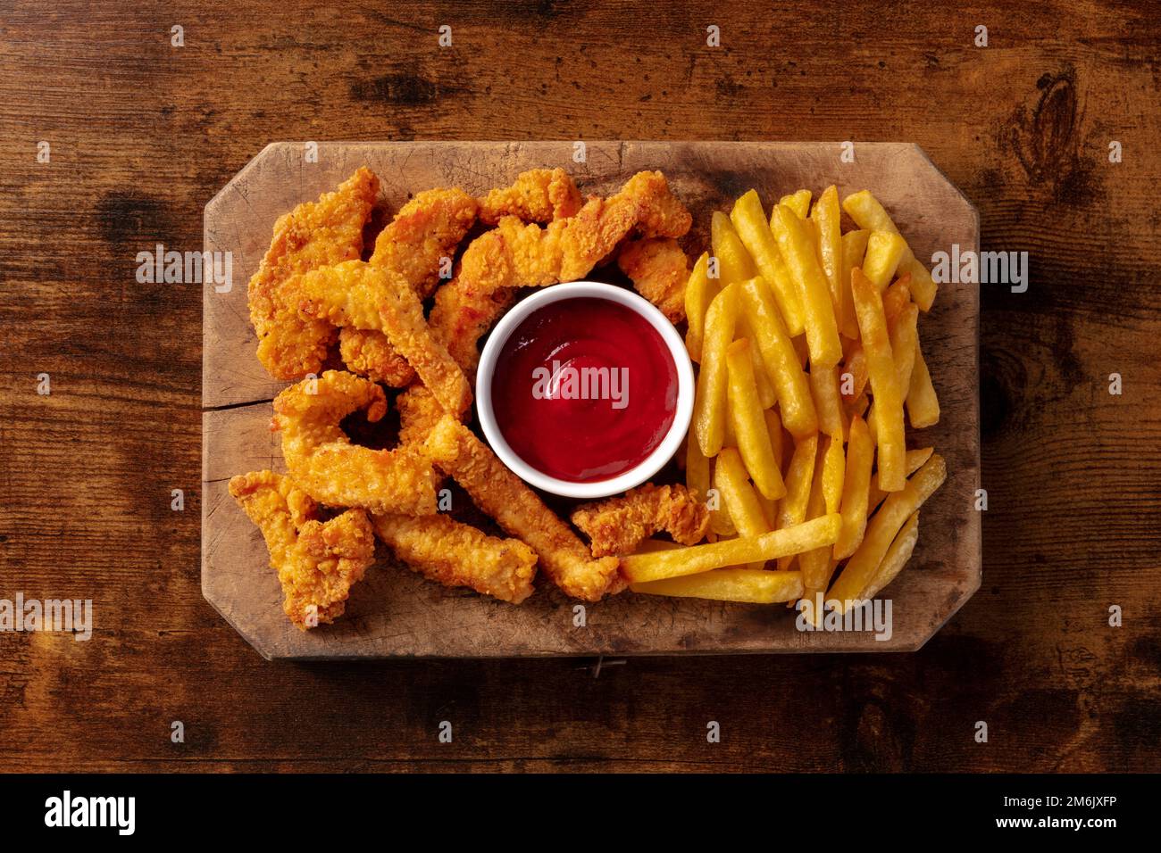 Chicken tenders, breaded and fried, with a barbecue sauce and French ...