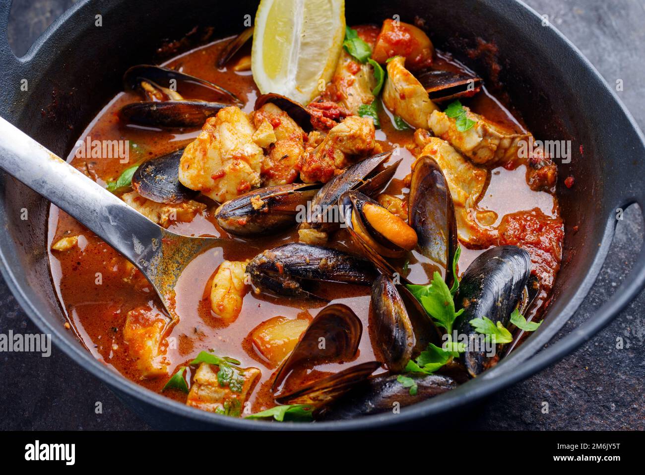 Modern style traditional Spanish seafood zarzuela de pescado with fish