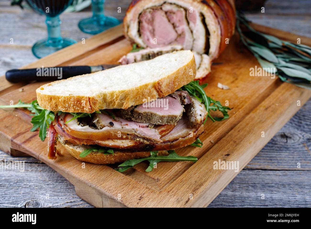 Traditional barbecue Italian porchetta pork belly roll meat sandwich