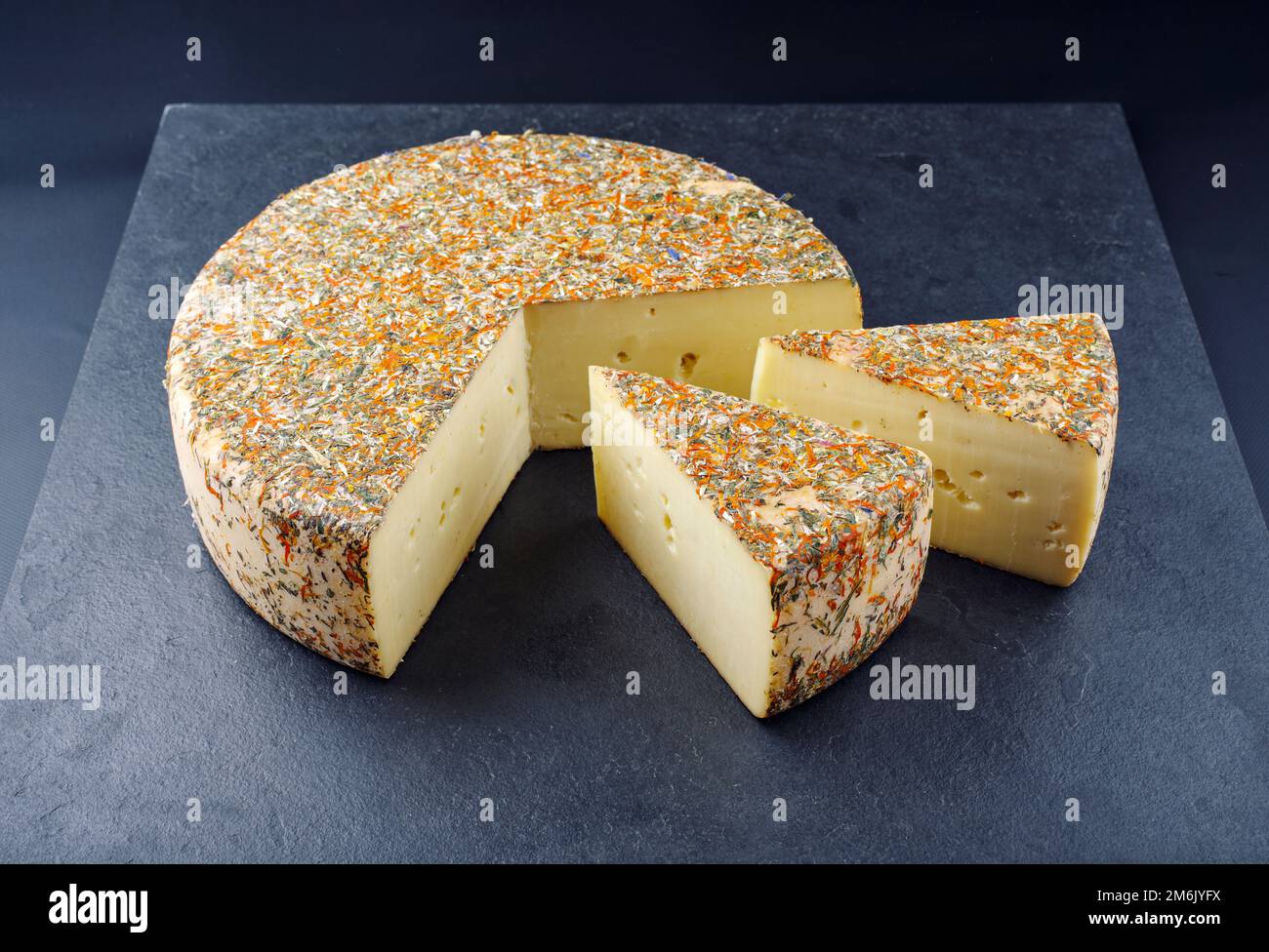 Traditional aged hay flower mountain cheese loaf of the Alps offered as