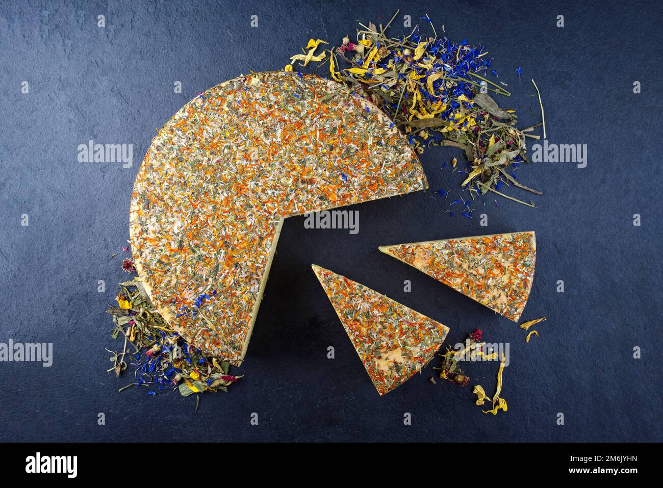 Traditional aged hay flower mountain cheese loaf of the Alps offered as