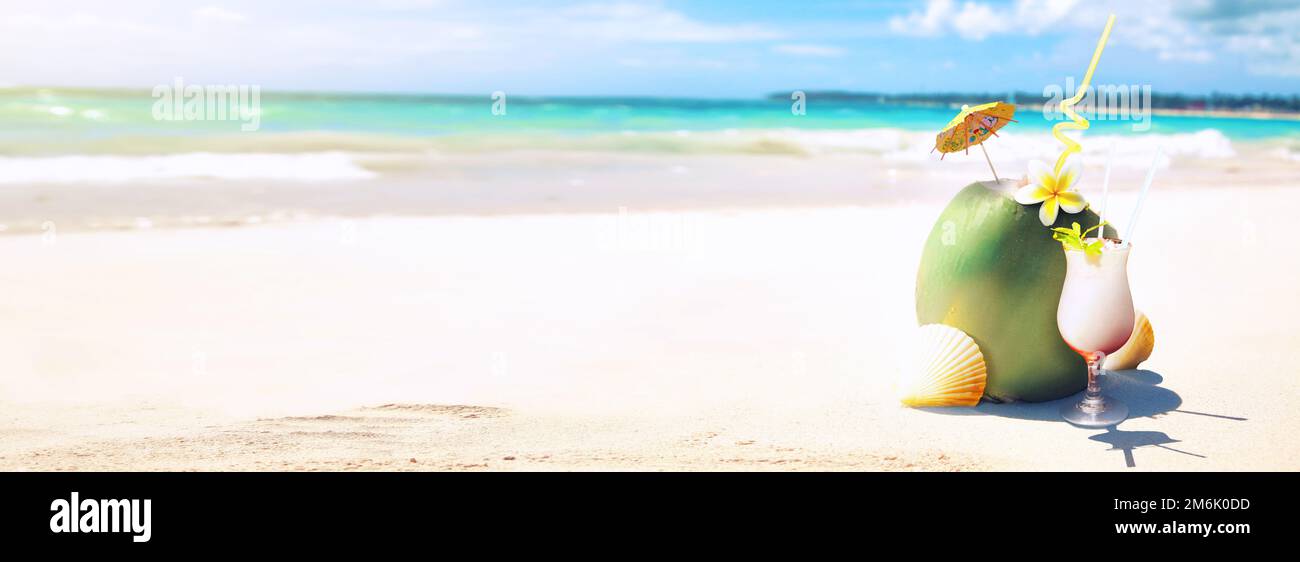 Summer coconut cocktail on the beach. Sunny day in topical island. Stock Photo