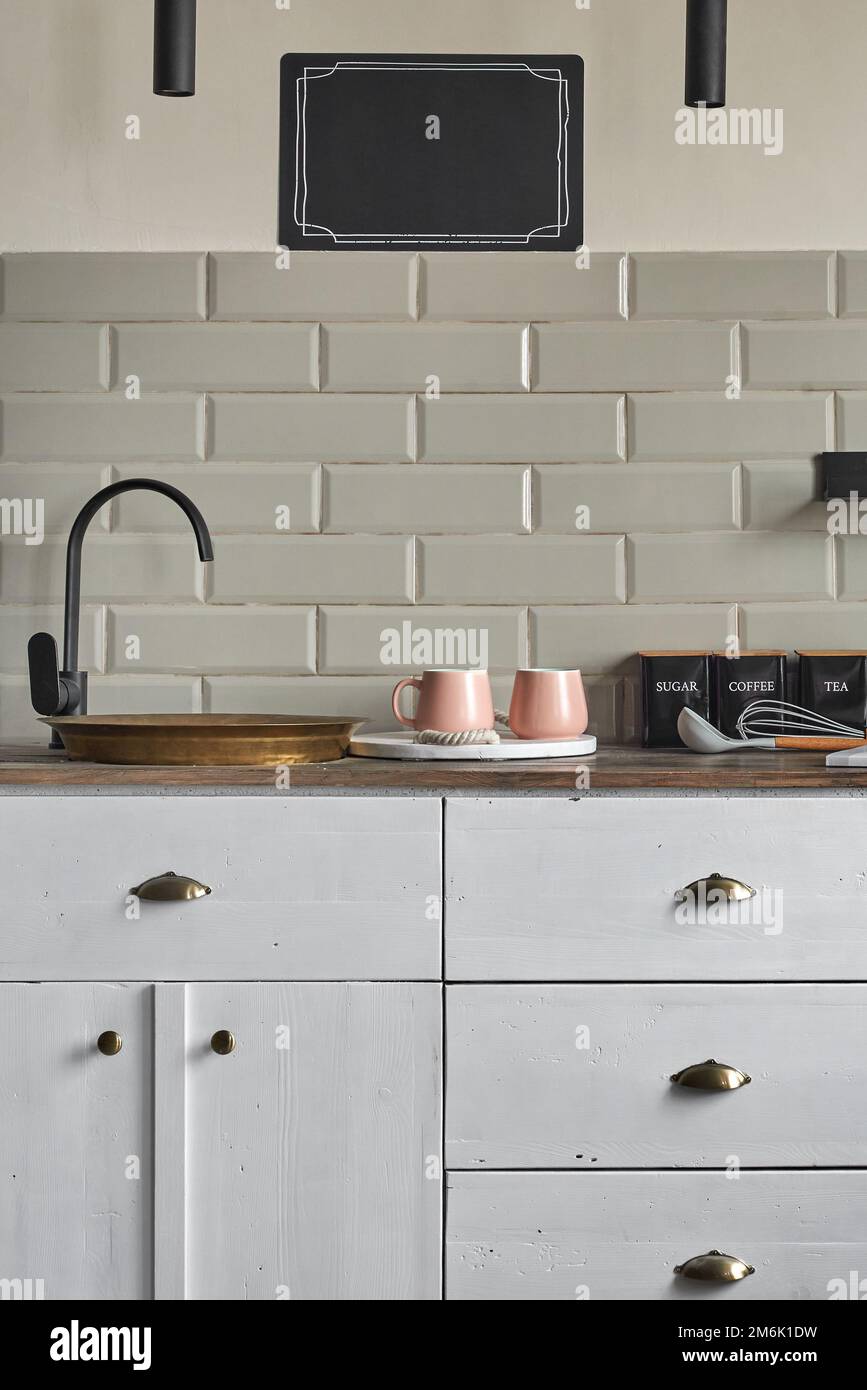 Residential house white cabinets with copper sink at kitchen counter. Stock Photo