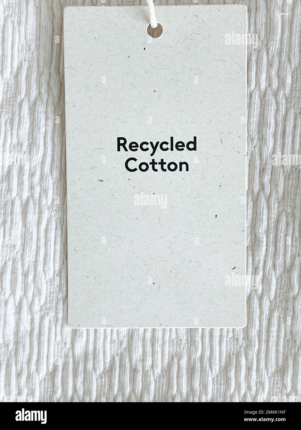 Recycled cotton fashion label tag, sale price card on luxury fabric