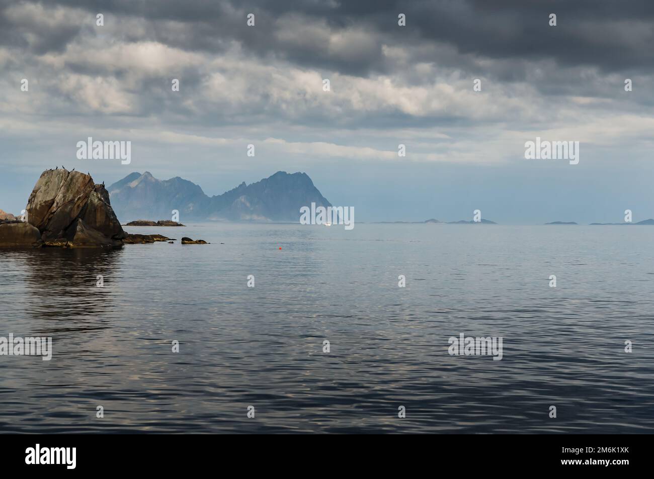 Sailing yacht is on the horizon, norwegian seascape, rocky coast with ...