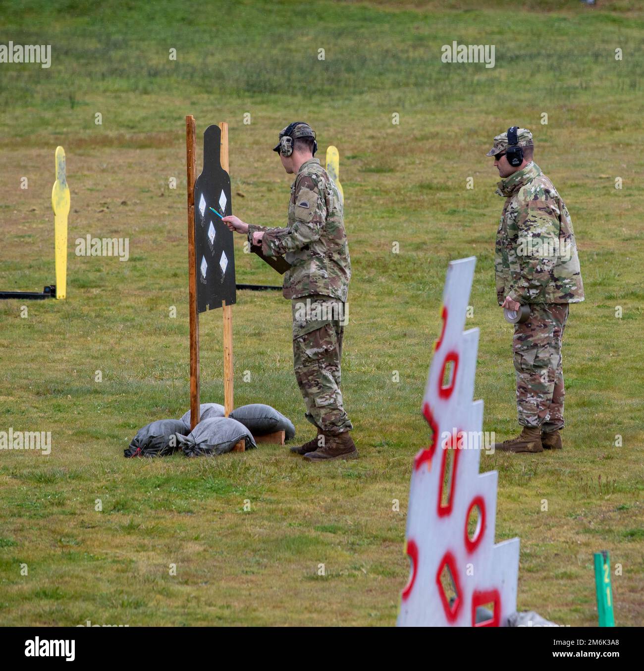 Oregon Army National Guard Staff Sgt. David Nelson, assigned to the 41st Infantry Brigade Combat Team, evaluates the number of target hits during the 2022 Adjutant General’s Match (TAG Match), held at Camp Rilea Armed Forces Training Center, Warrenton, Oregon, April 30. Over the course of three days, Soldiers and Airmen competed in five combat-focused events that demonstrated their proficiency using their service M4 carbine rifle, M9 pistol, and M500 shotgun. Stock Photo