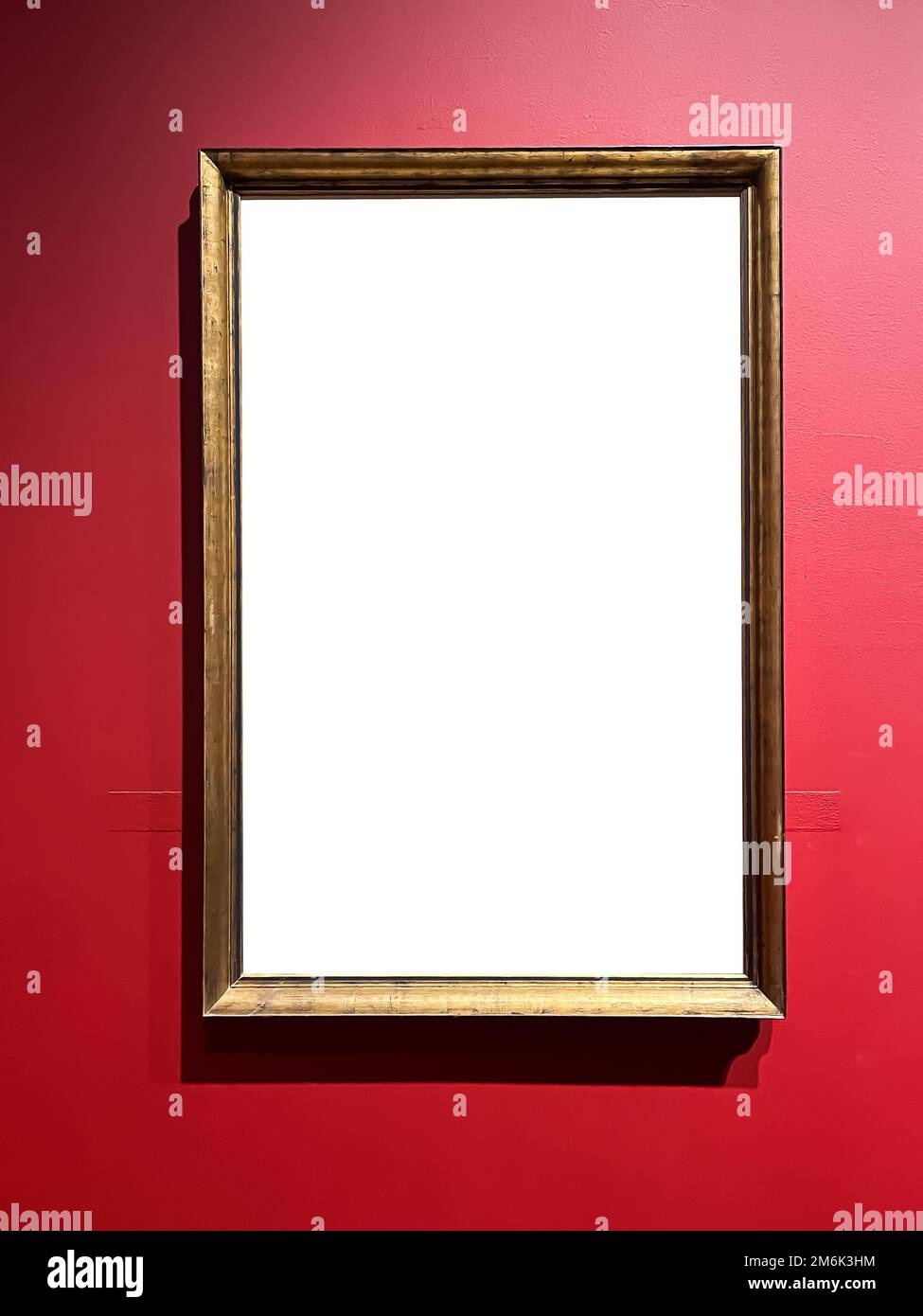 Antique wooden art fair gallery frame on the wall at auction house or museum exhibition, blank template with empty white copyspa Stock Photo