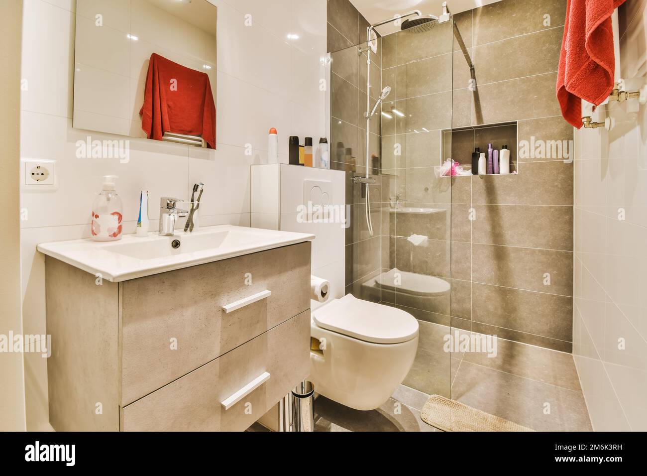 a bathroom with a toilet, sink and shower stall in the same color as it