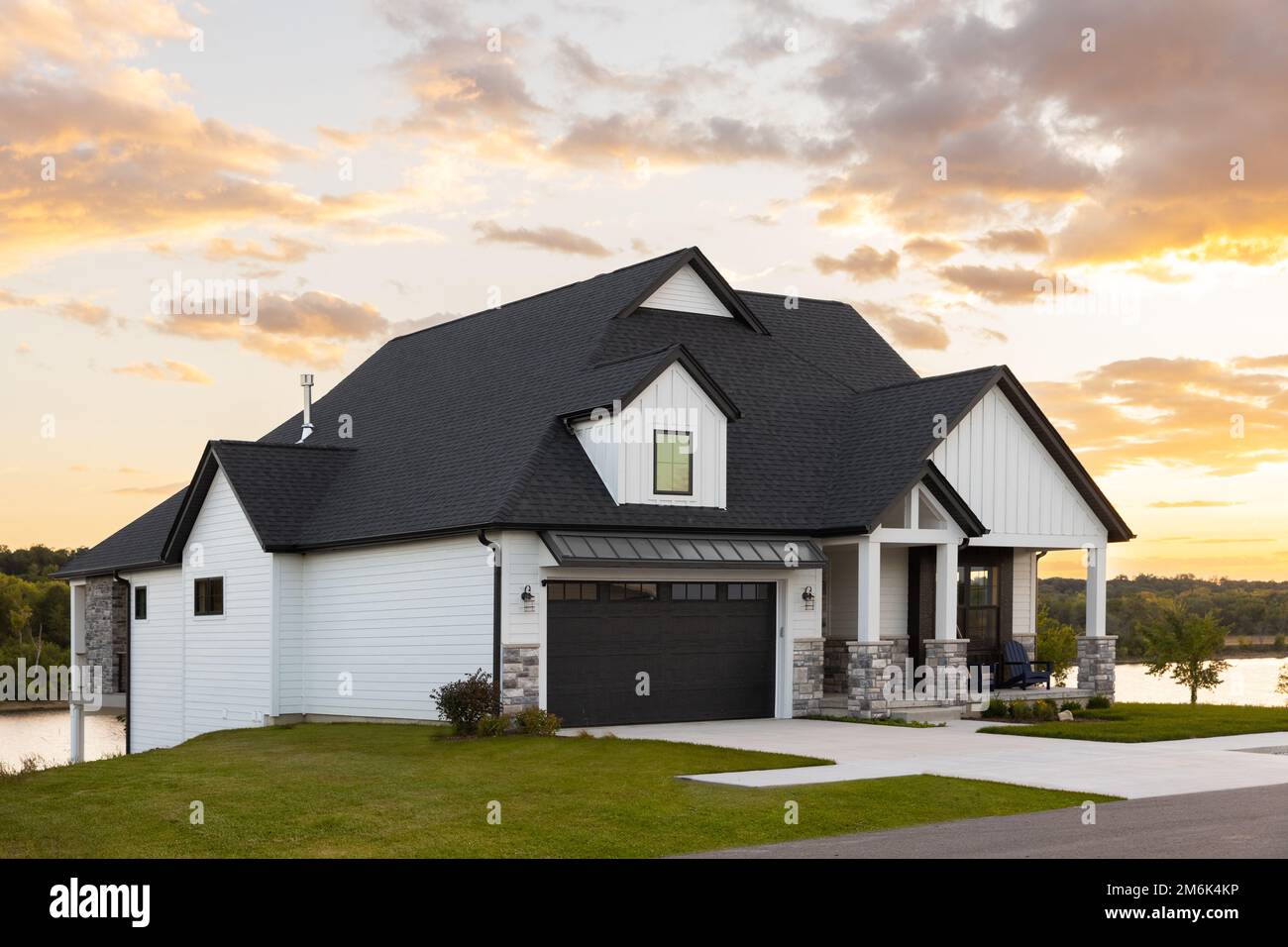 A Black And White Luxury Home With A Two Car Garage And Black Door a-black-and-white-luxury-home-with-a-two-car-garage-and-black-door