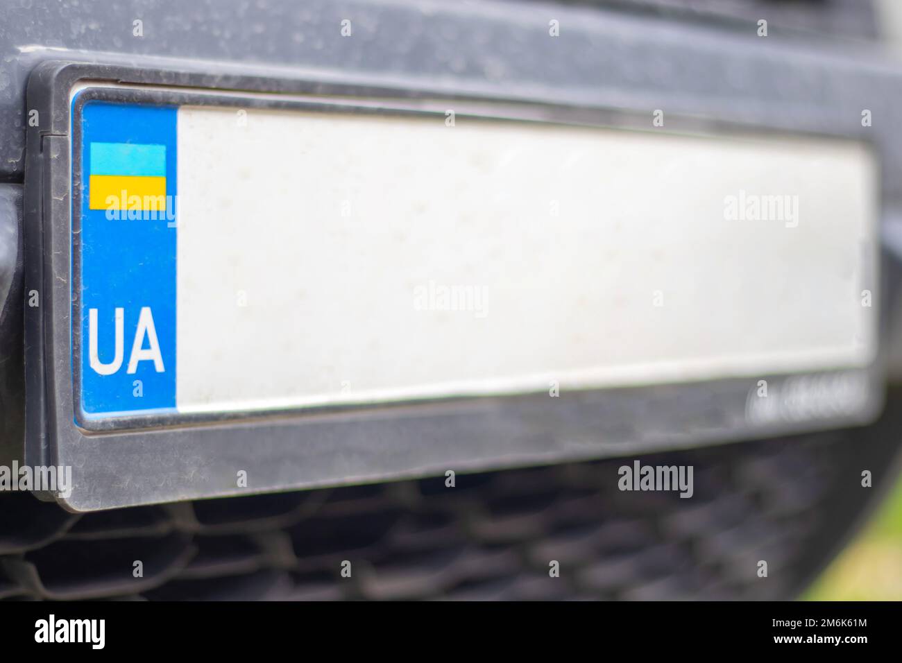 Ukrainian license plate without numbers and letters on the bumper close-up. Symbol of nationality and yellow-blue flag. Individu Stock Photo