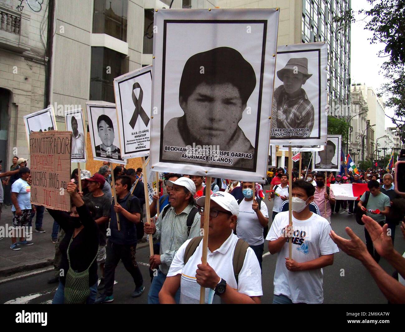 People carrying the portraits of those killed in the last December ...
