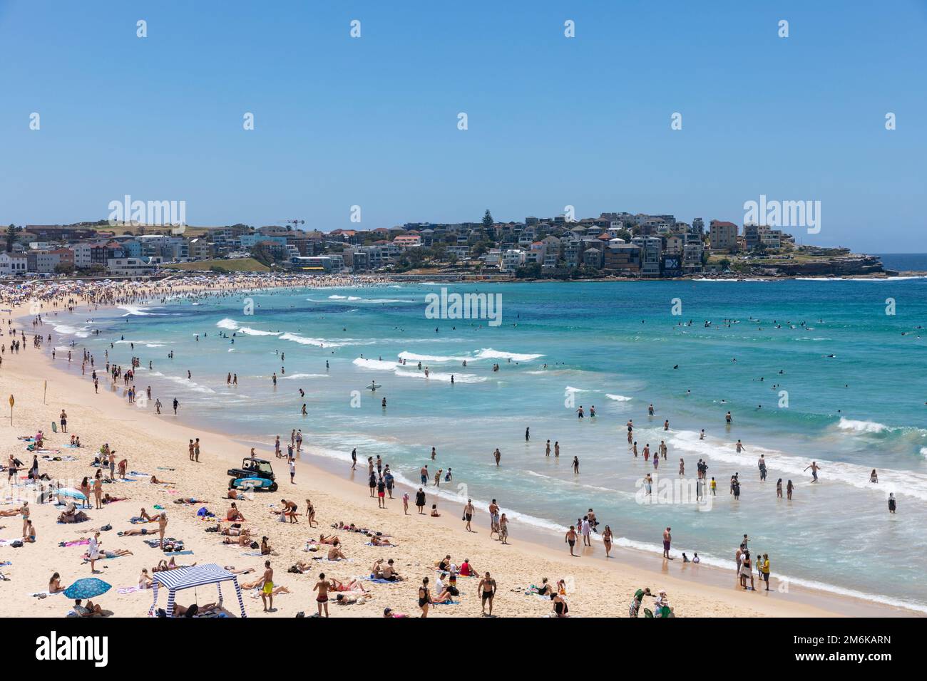 2023 Bondi Beach on a clear sky summers day, beach is crowded with sunbathers and people relaxing swimming in oceanview North,Sydney,NSW,Australia Stock Photo