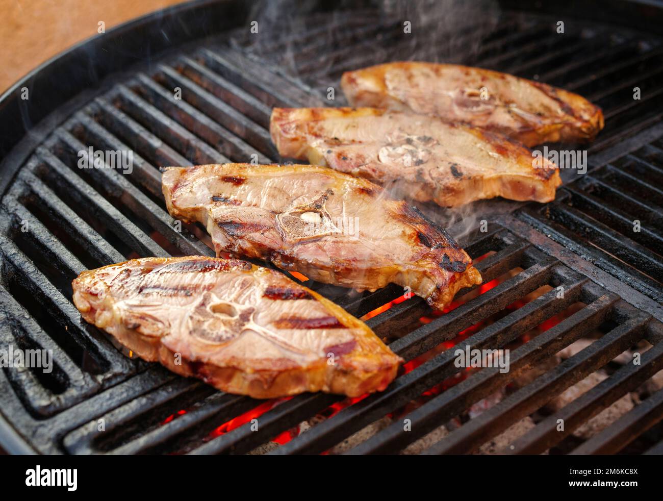 Barbecue lamb saddle back chop steak grilled as closeup on a charcoal
