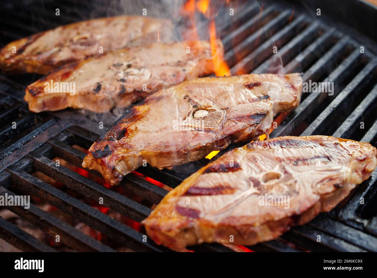 Barbecue lamb saddle back chop steak grilled as closeup on a charcoal