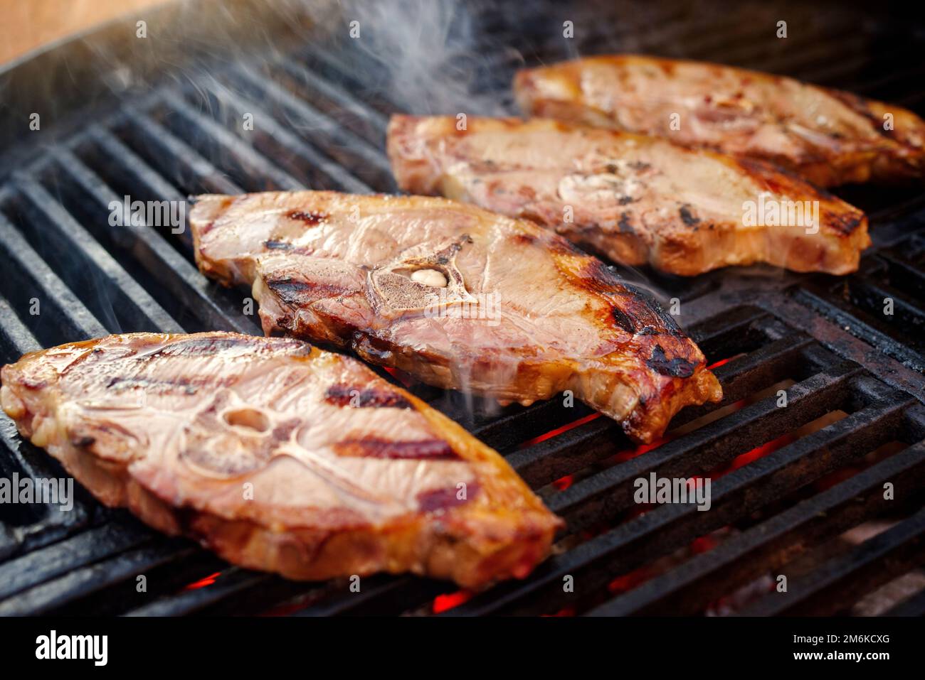 Barbecue lamb saddle back chop steak grilled as closeup on a charcoal