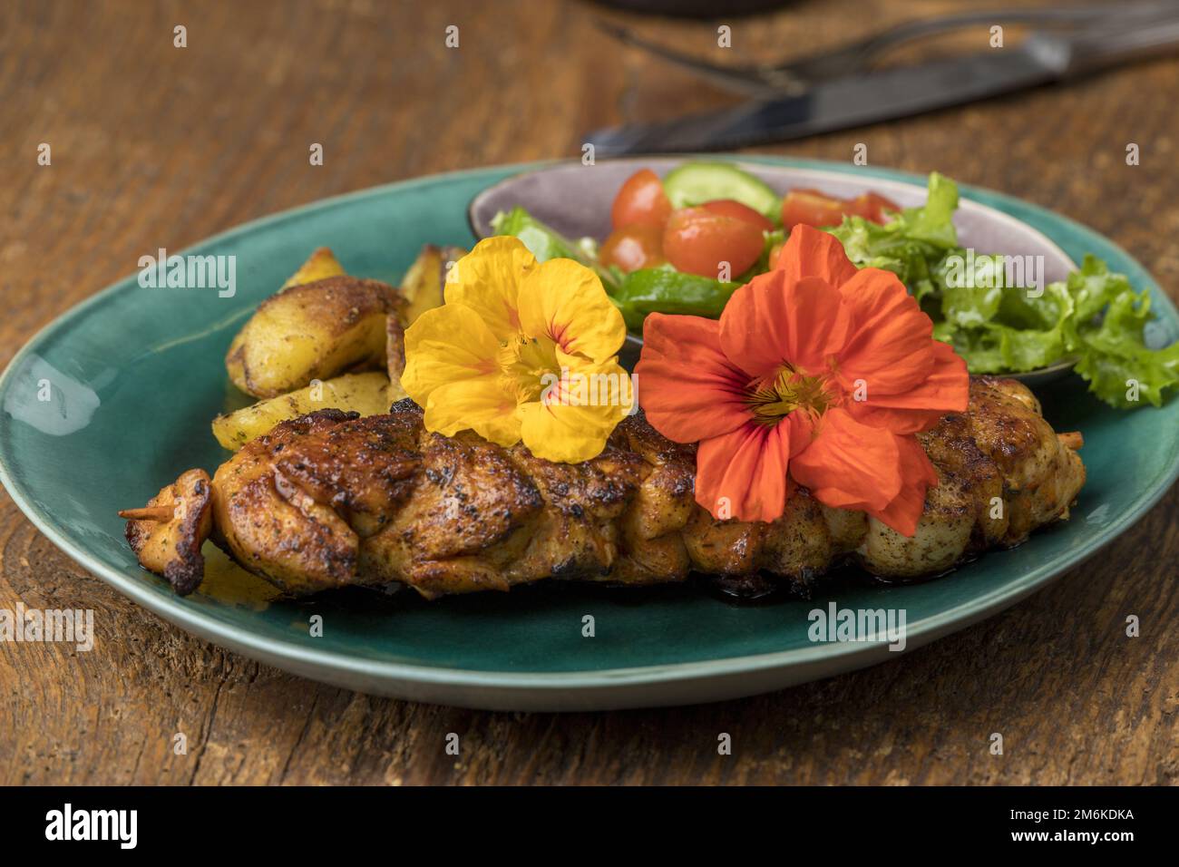 Nasturtium flowers on a grilled steak Stock Photo