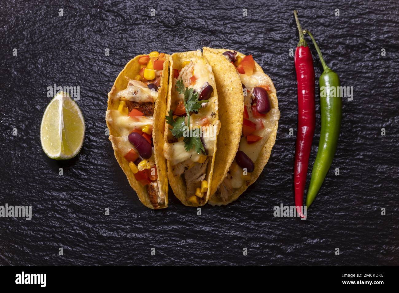 Three Mexican tacos on slate Stock Photo