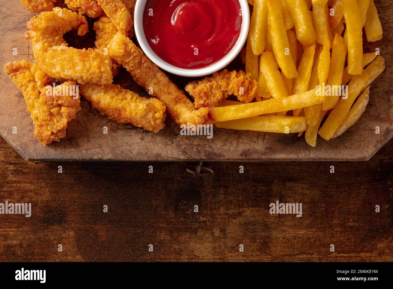 Chicken tenders, breaded and fried, with a bbq sauce and French fries