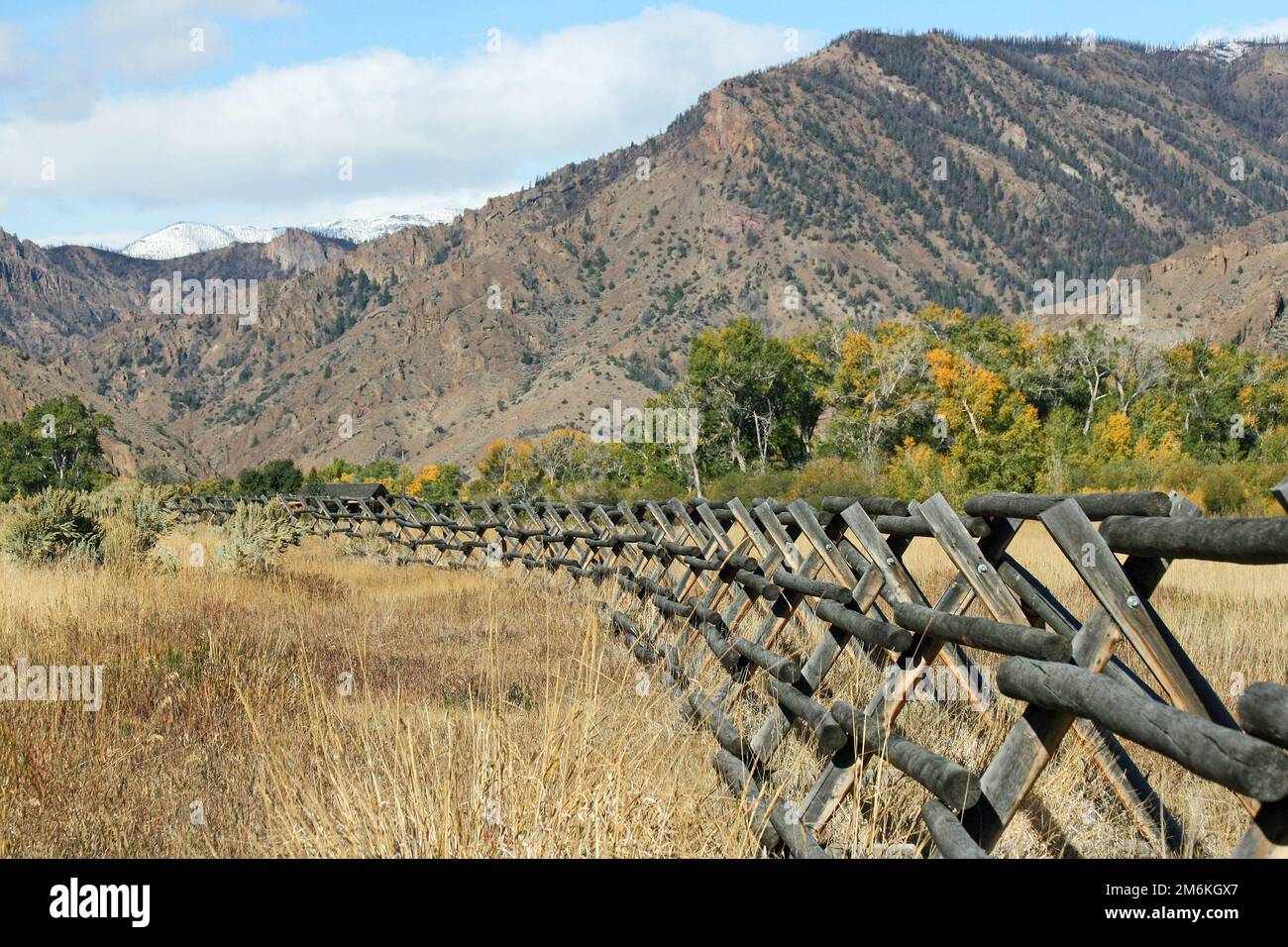 Wooden fence and mountains, Wyoming Stock Photo