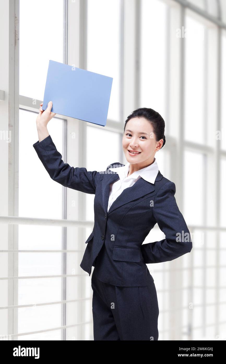 Young business lady holding a folder Stock Photo