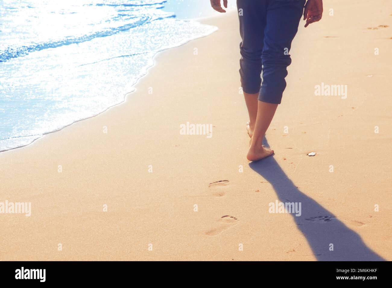 Walking on the beach, leaving footprints in the sand Stock Photo - Alamy