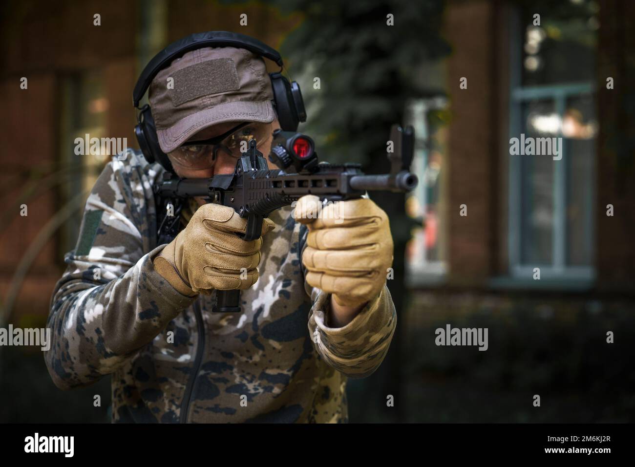 Tactical training course young man. Outdoor shooting range. Shotgun weapon action course. Private military contractor at tactica Stock Photo